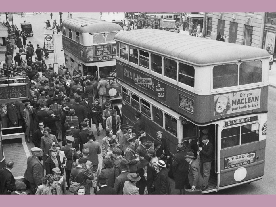 London at War, 1942 Crowds of men and women, including servicemen, queue for buses in the Strand. Two buses, the number 13 to Golders Green and number 15 to Ladbroke Grove can be seen in the foreground as passengers jump on and off. Just visible in the background are the base of Nelson's Column in Trafalgar Square (right) and Admiralty Arch (left).