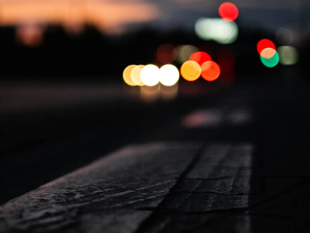 Blurred car lights in the distance at night.