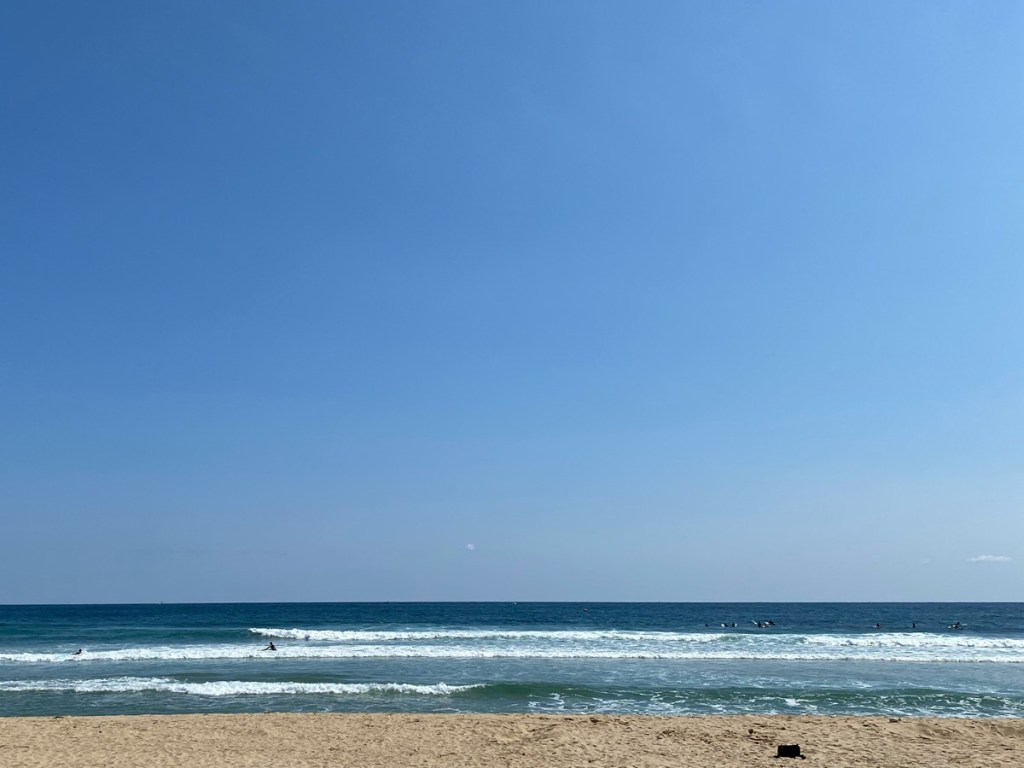 A view out onto the sea and a cloudless sky