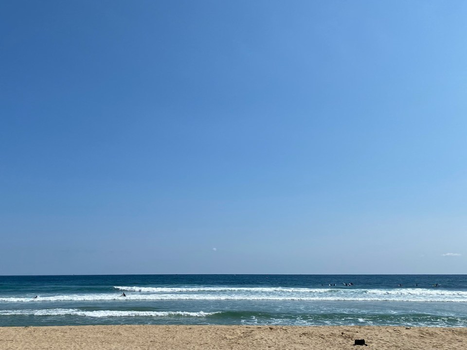 A view out onto the sea and a cloudless sky